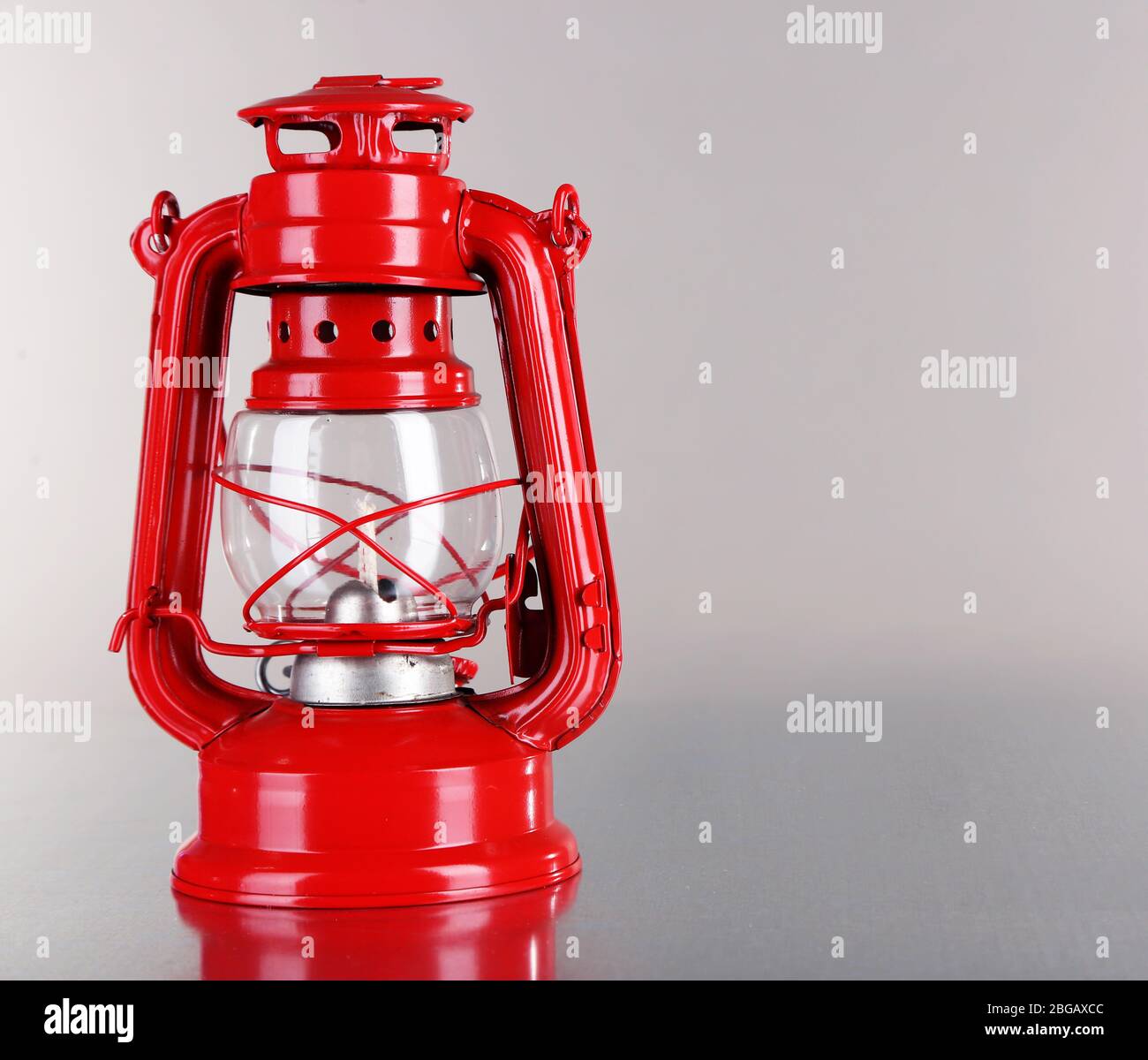 Red kerosene lamp on grey background Stock Photo - Alamy