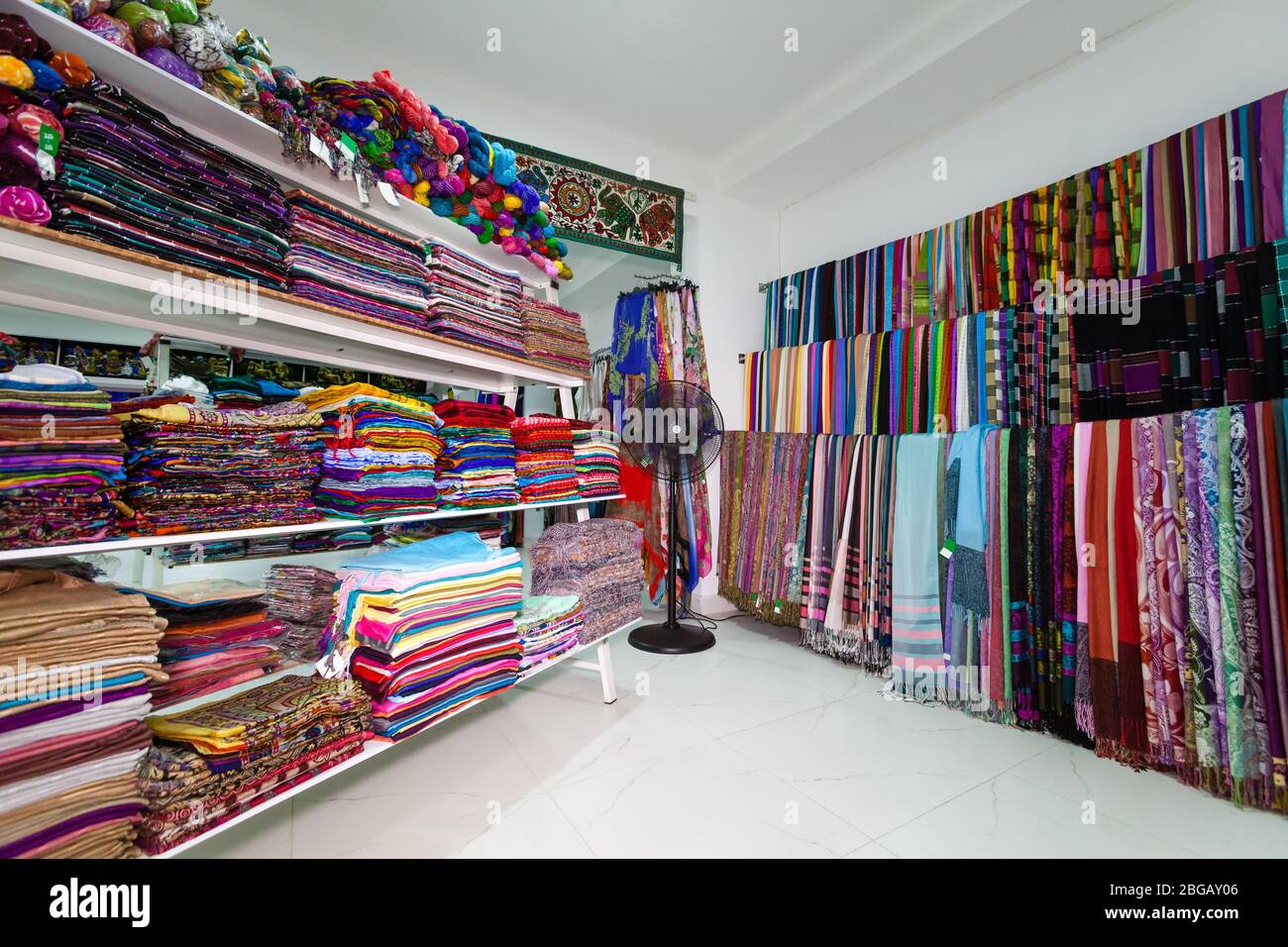 Textile shop in Indian clothing. Sari, traditional Indian dress. Shelves with fabrics of various colors. Location: Kandy, Sri Lanka Stock Photo