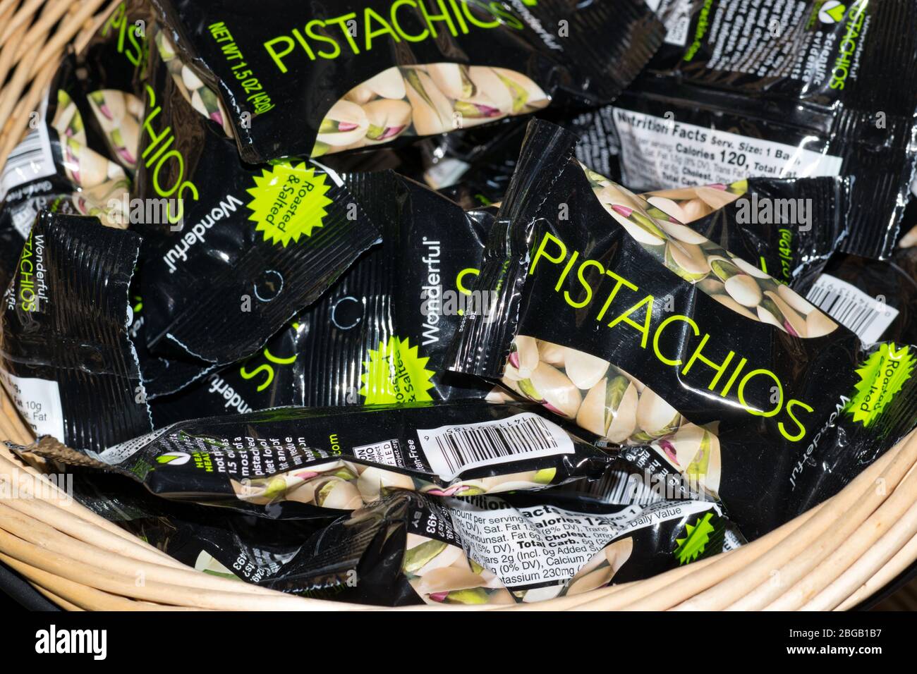 Pistachio nut packages in a wicker basket. Wonderful brand pistachio