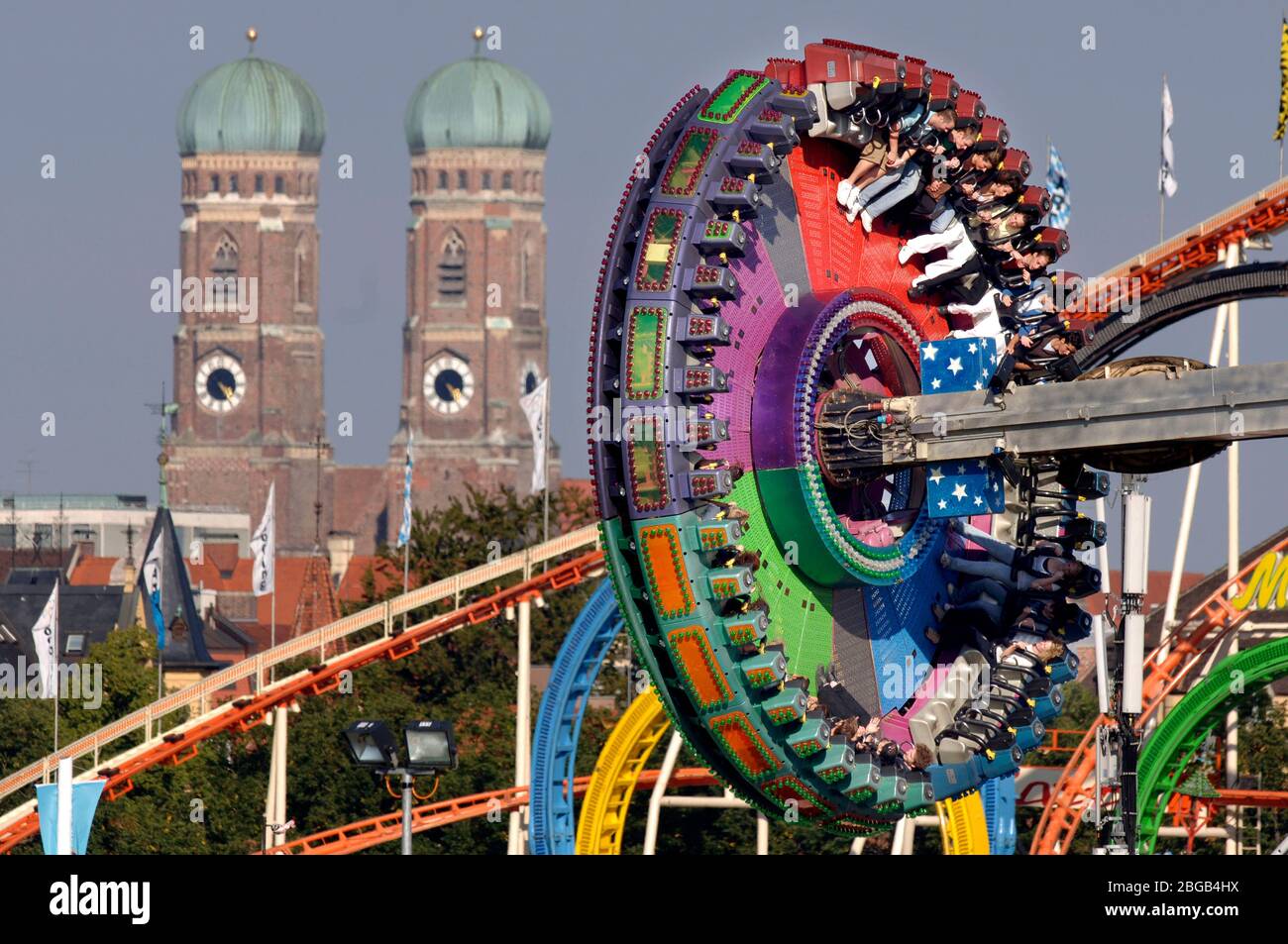 Munich, Deutschland. 21st Apr, 2020. Because of the corona virus pandemic: Oktoberfest 2020 is canceled. Archive photo; Feature, towers of the Frauenkirche - a ride in the foreground, Oktoberfest Muenchen, Wiesn, Wiesen, Theresienwiese, 09/21/2006. | usage worldwide Credit: dpa/Alamy Live News Stock Photo