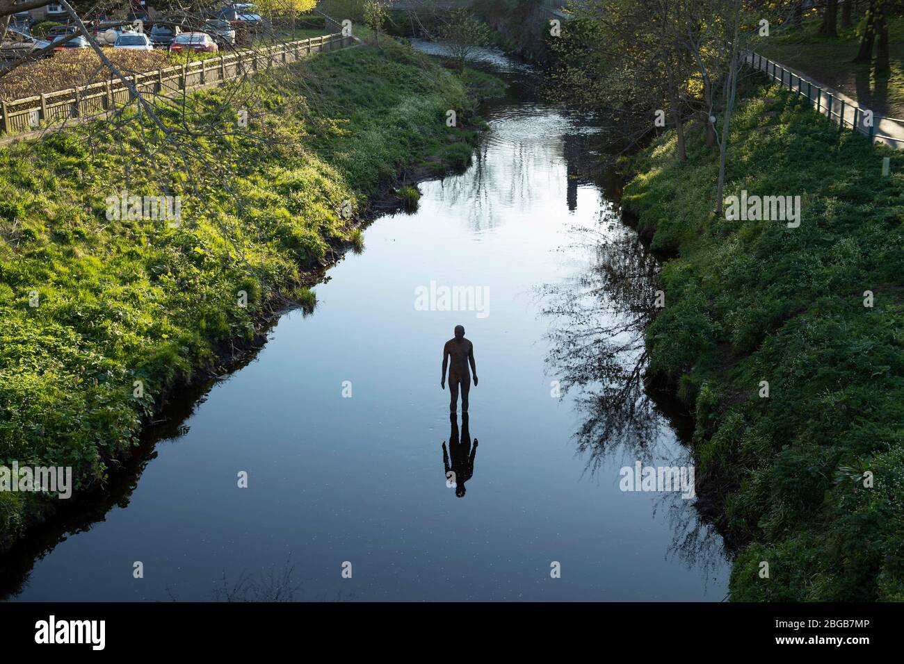 One of artist Antony Gormley's "6 TIMES" statues in the Water of Leith
