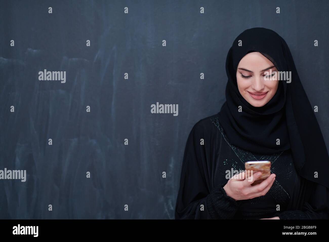 young modern muslim business woman using smartphone wearing hijab ...