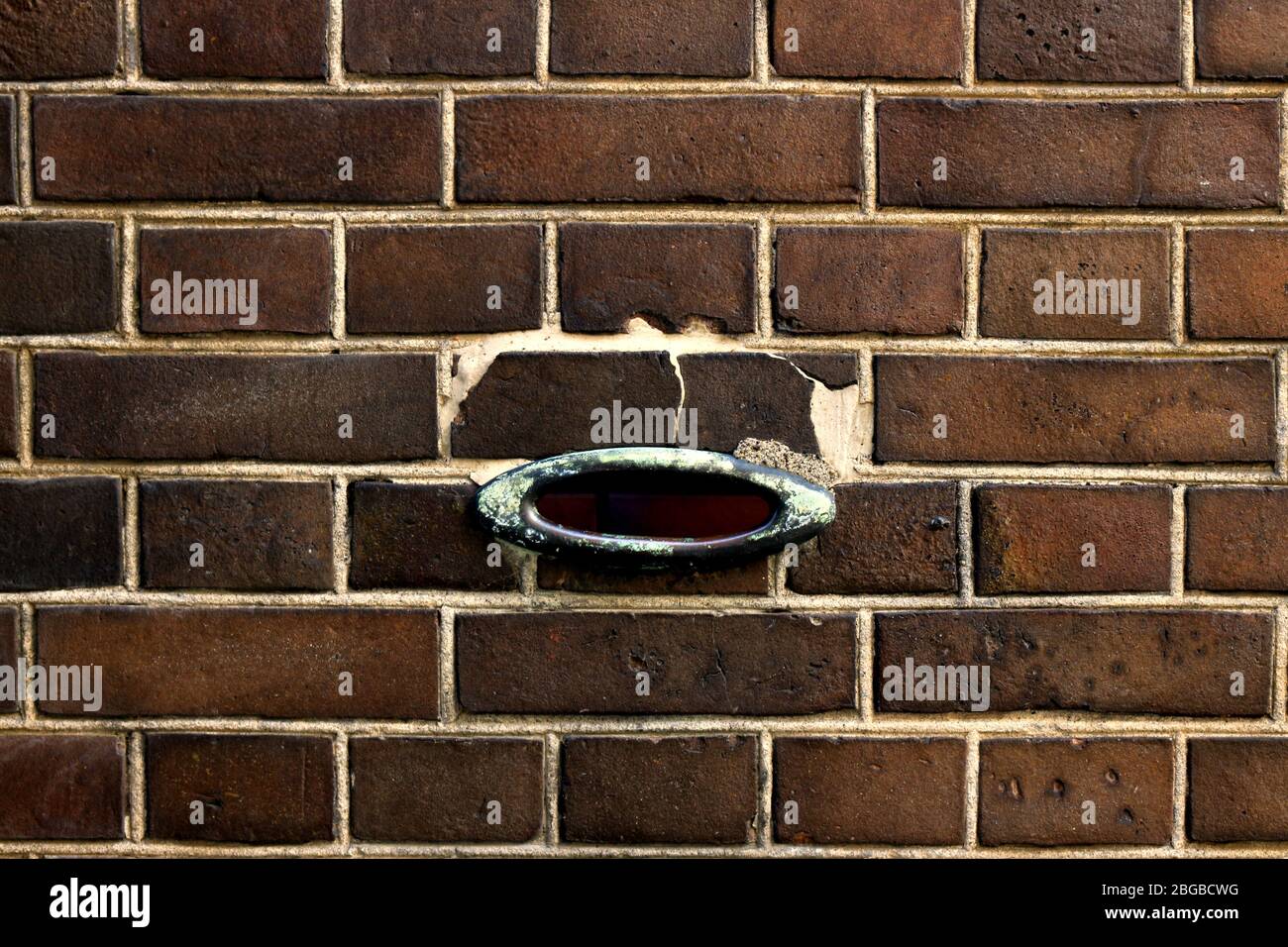 An antique design mailbox Input port on an old brick wall Stock Photo