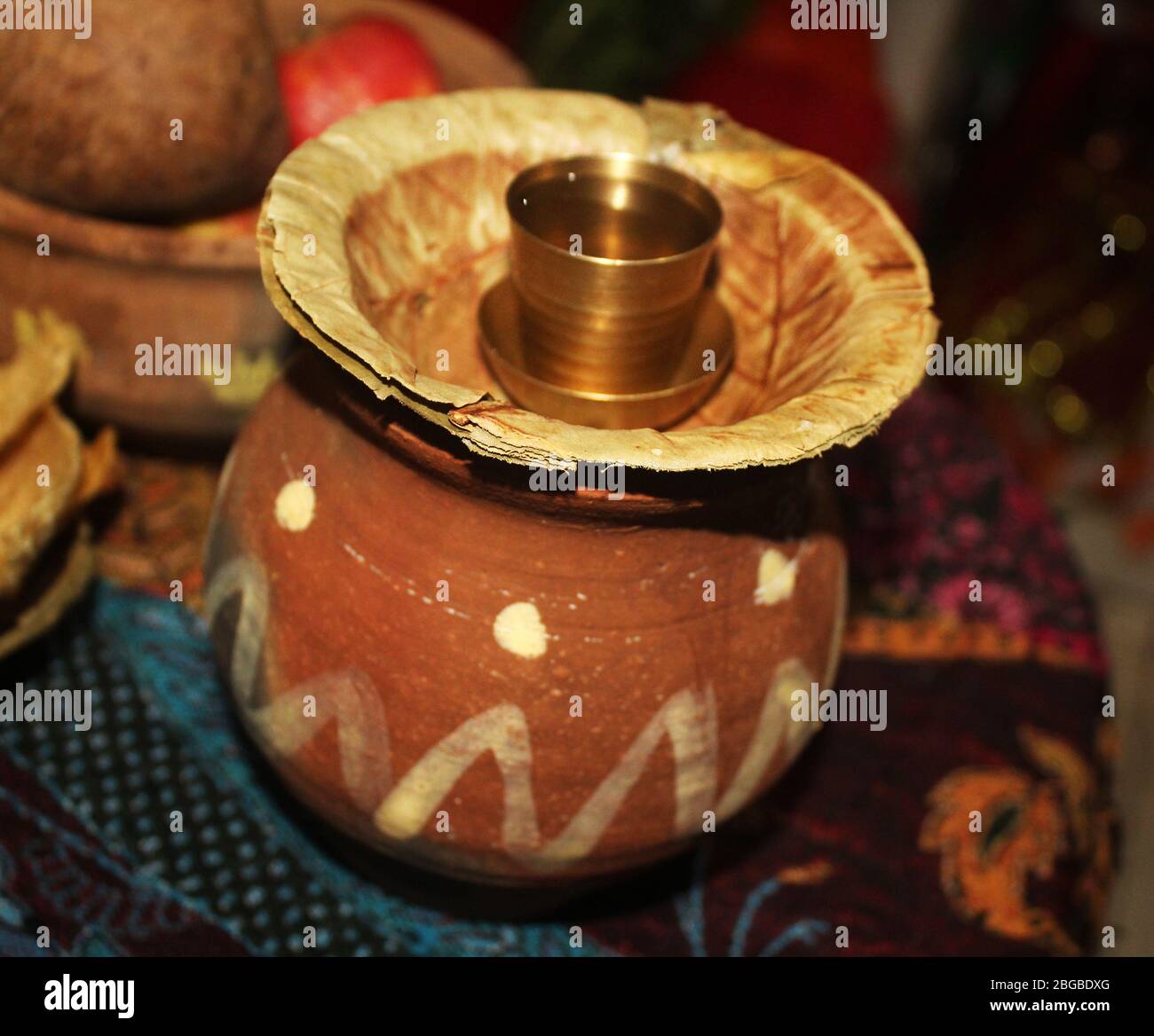 Drinking water with brass glass served in Mud pot,with a typical Indian ...
