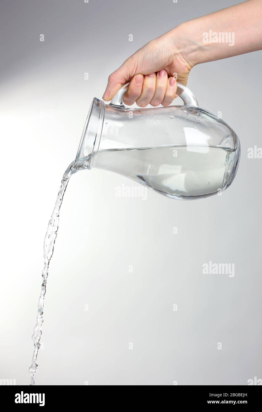 Pour water from a pitcher into a glass Stock Photo - Alamy