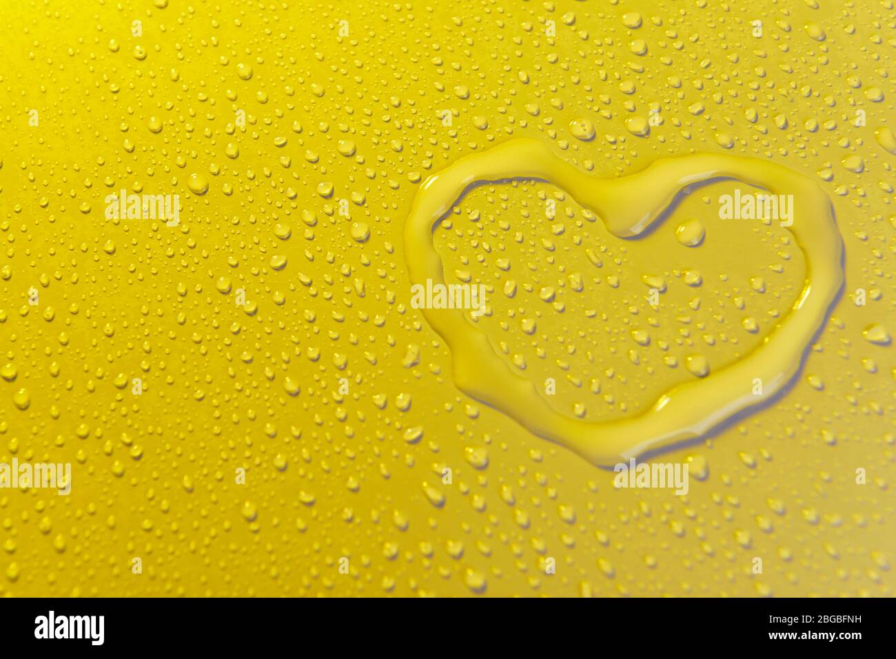 Water drops on yellow background Stock Photo - Alamy