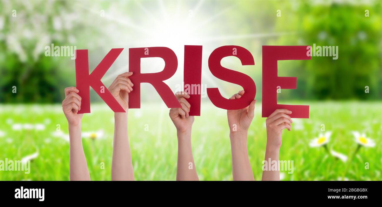 People Hands Holding Word Krise Means Crisis, Grass Meadow Stock Photo