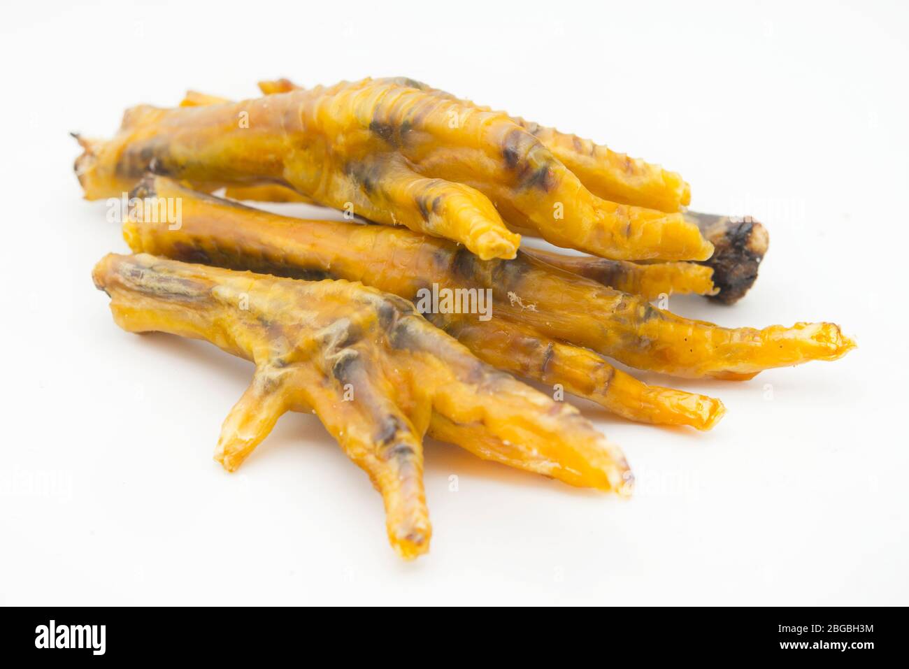 dehydrated chicken feet in white background Stock Photo - Alamy