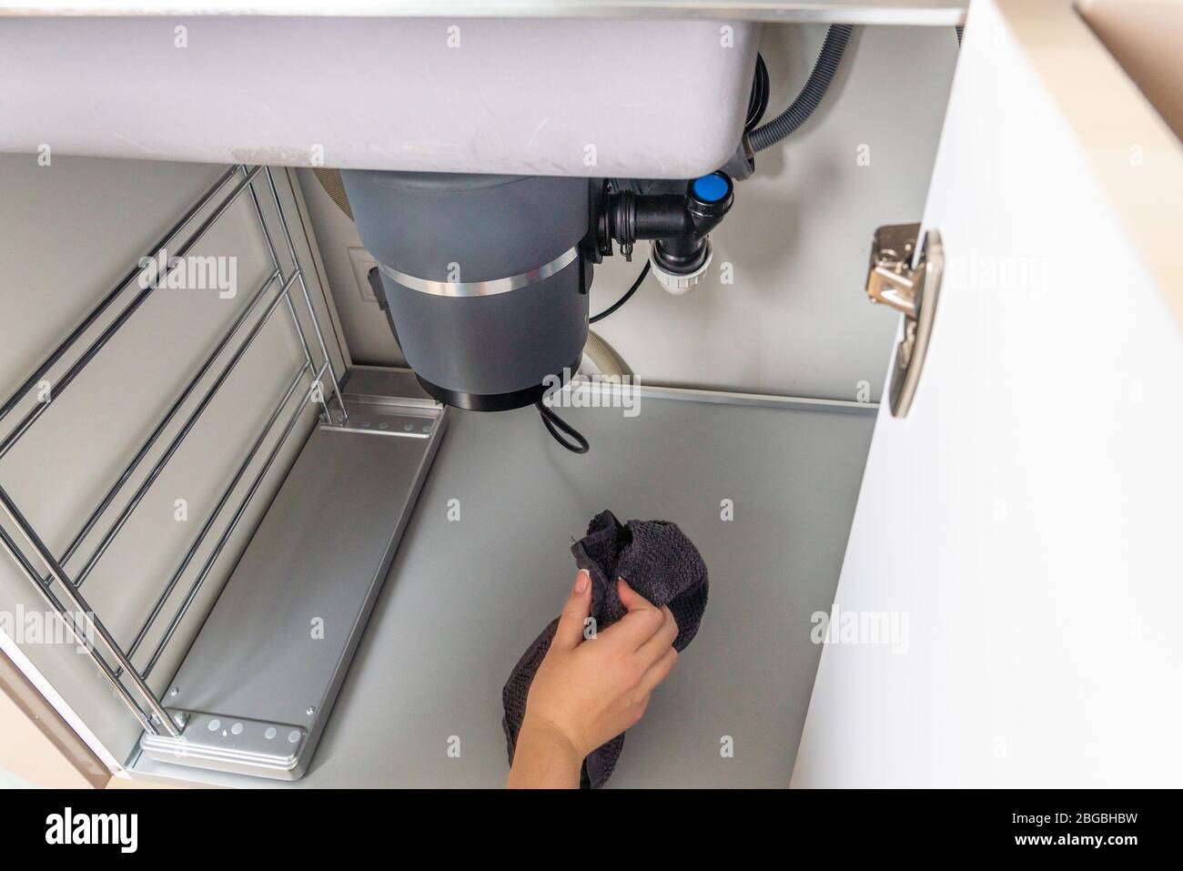 Waste disposal leak under a sink, broken garbage chopper Stock Photo