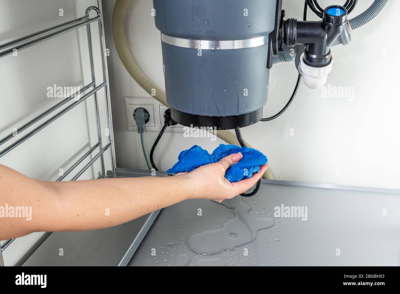 Waste disposal leak under a sink, broken garbage chopper Stock Photo