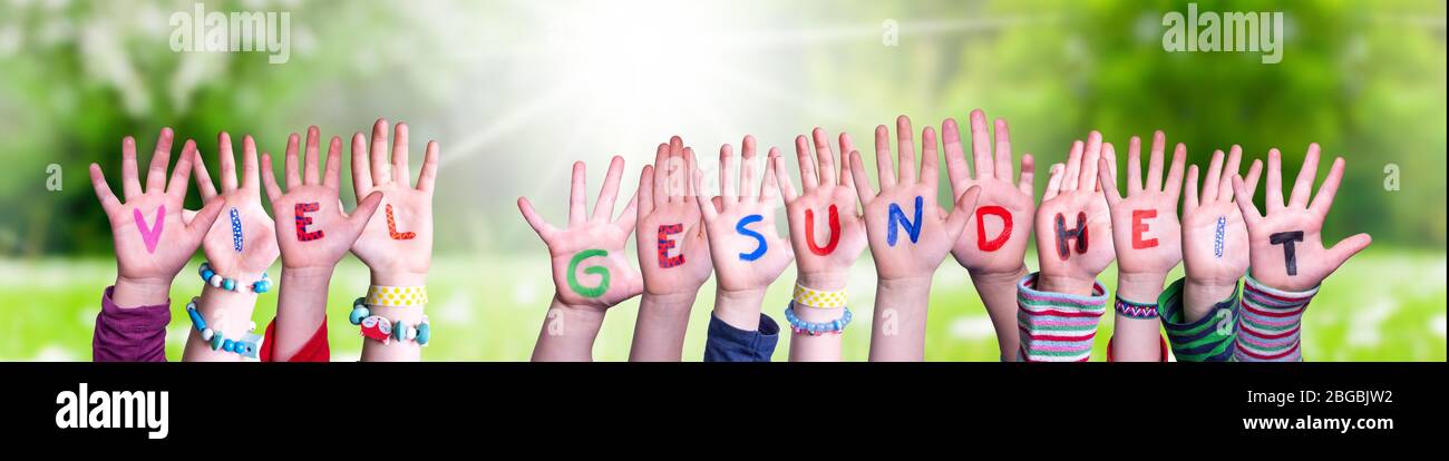 Kids Hands Holding Word Viel Gesundheit Means Stay Healthy, Grass Meadow Stock Photo