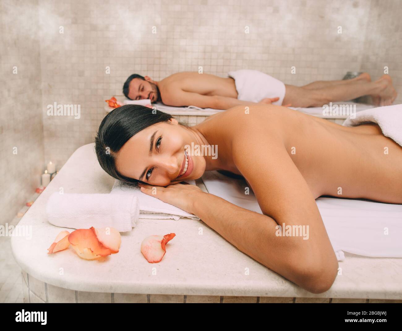 Beautiful woman and her boyfriend enjoy a Turkish bath. Hot steam warmed the bodies of a man and a woman in a hammam Stock Photo