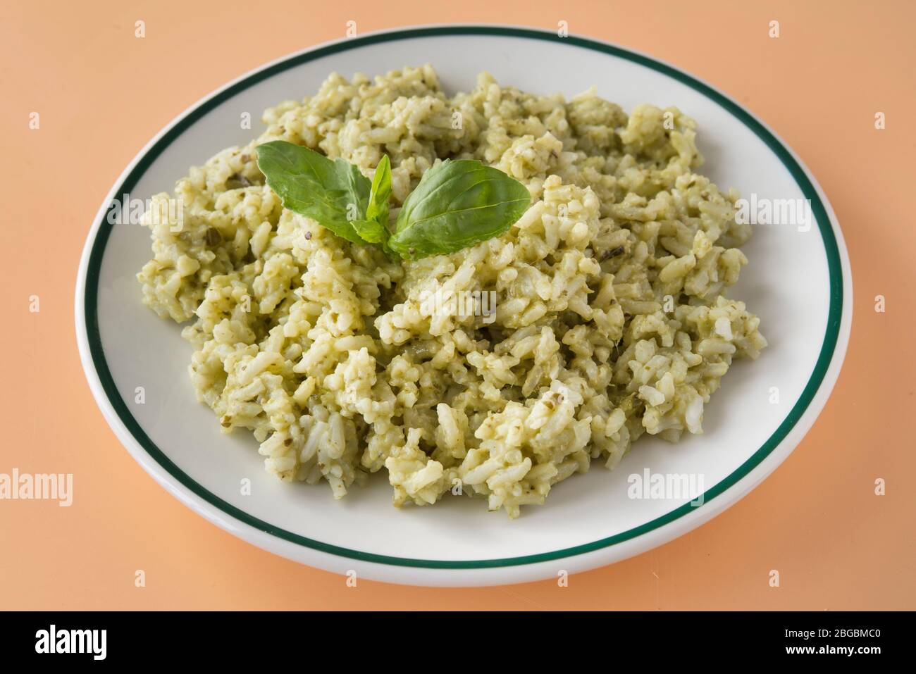 Traditional Mexican Arroz Verde green rice dish made of long-grain rice, spinach, cilantro and garlic. Stock Photo