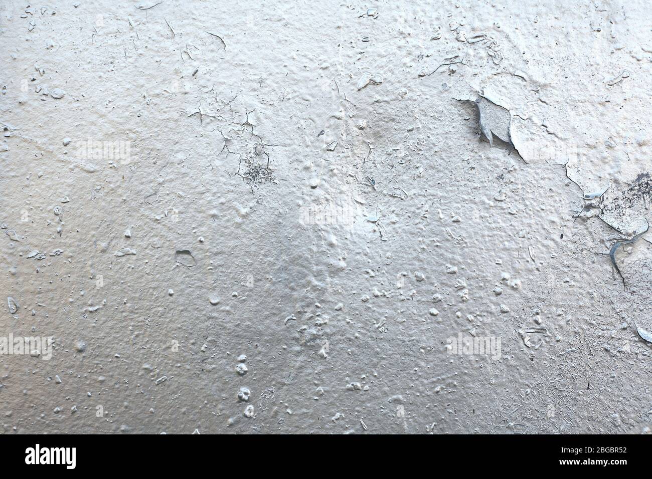 The texture of the old painted wall is covered with cracks and ...
