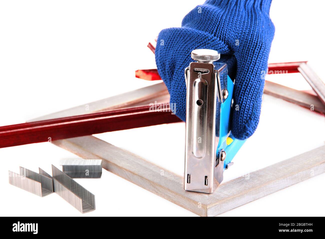 Fastening wooden frame using construction stapler isolated on white Stock  Photo - Alamy