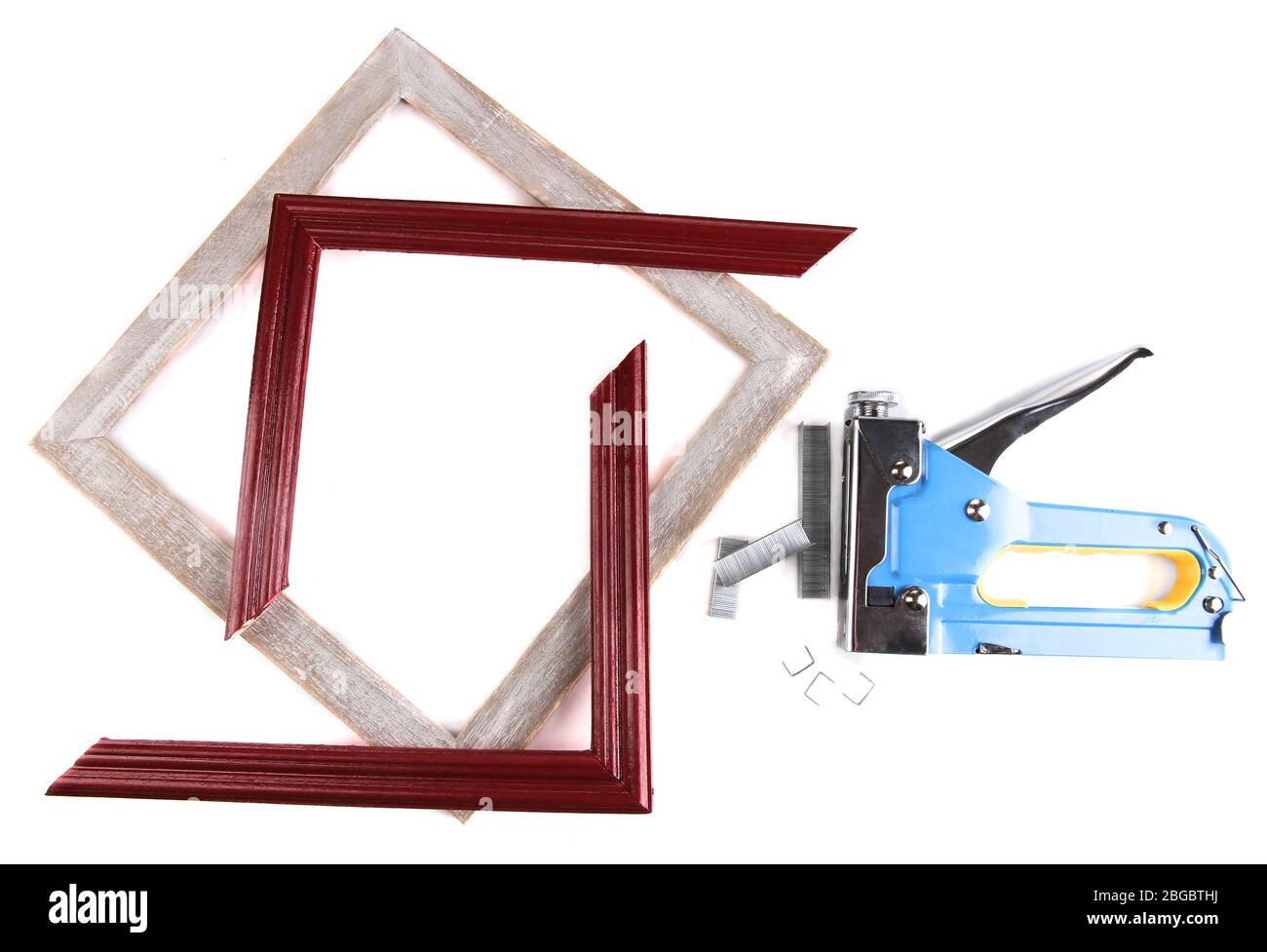 Construction stapler and wooden frames isolated on white Stock Photo