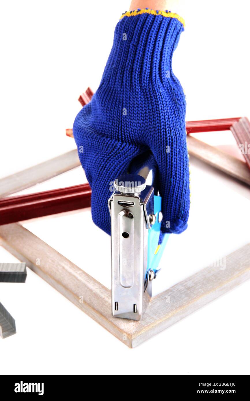 Fastening wooden frame using construction stapler isolated on white