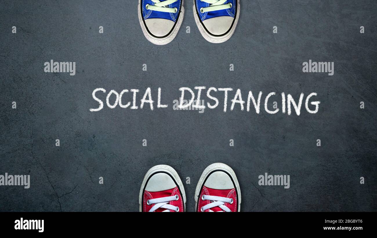 Social distancing. two people keep spaced between each other for social distance, increasing the physical space between people to avoid spreading illn Stock Photo