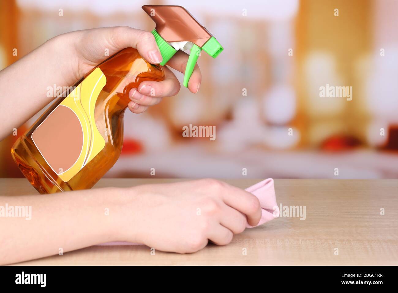Hand cleaning wooden table with furniture polish Stock Photo Alamy
