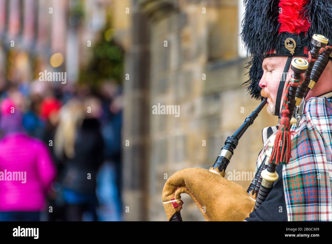 Edinburgh, Scotland Dec 2018. Scottish bagpiper dressed in traditional red and black tartan