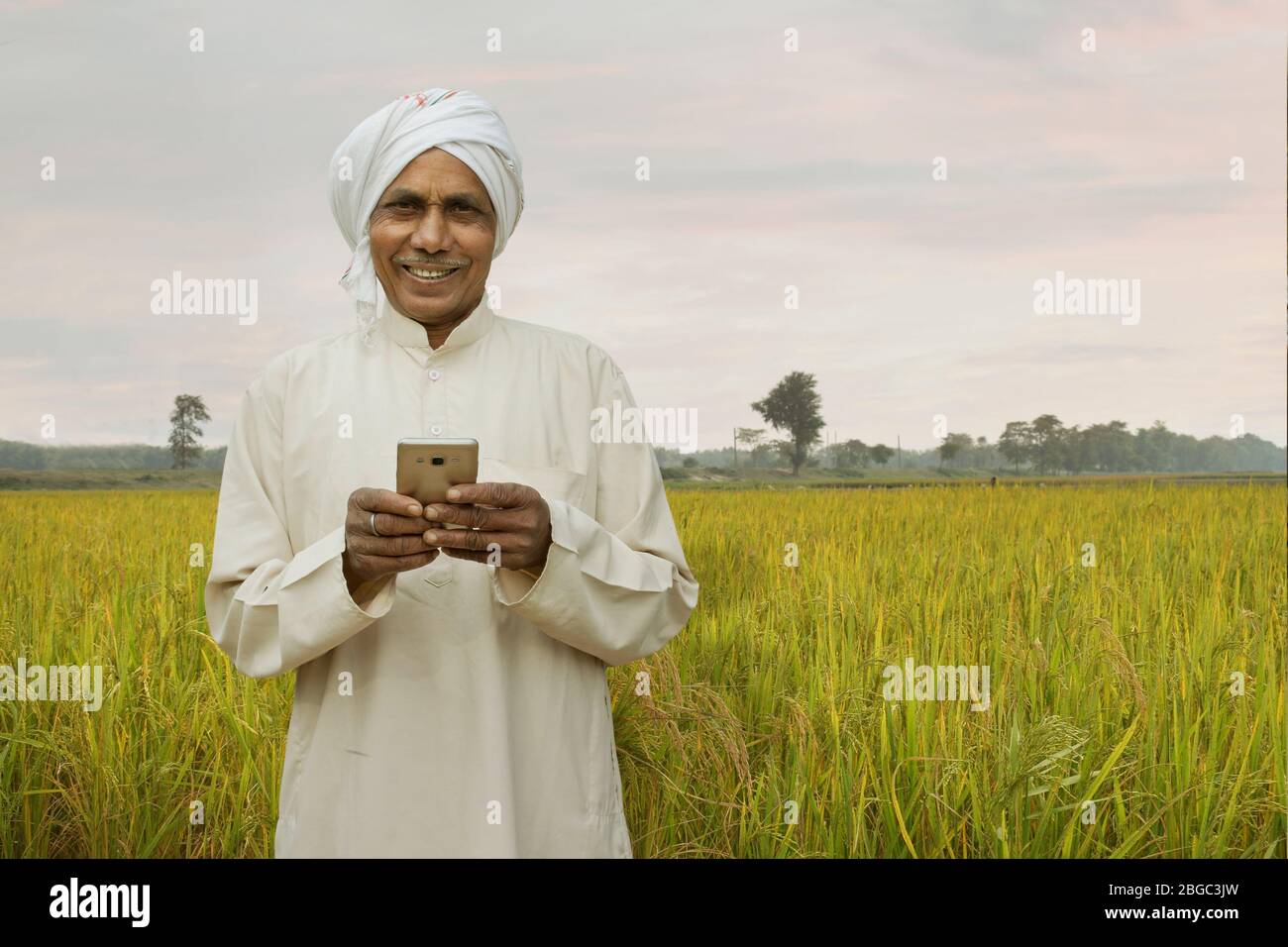 farmer with cellphone smiling Stock Photo