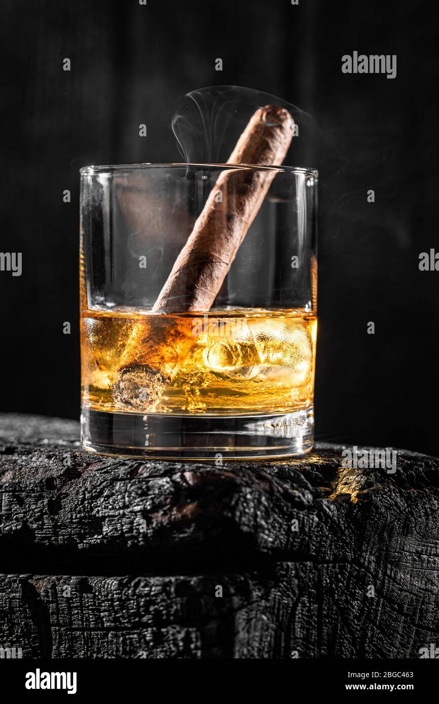 Cigar put out in a glass of whiskey Stock Photo Alamy