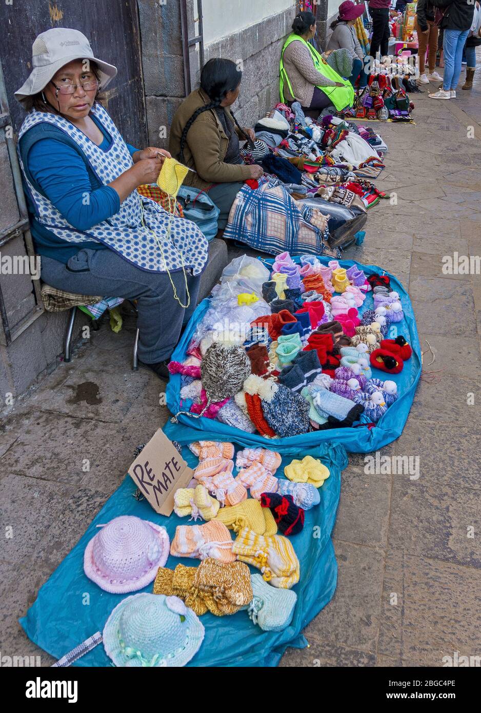 Locals selling their handicrafts on the street outside San Pedro Market in Cusco, Peru Stock Photo