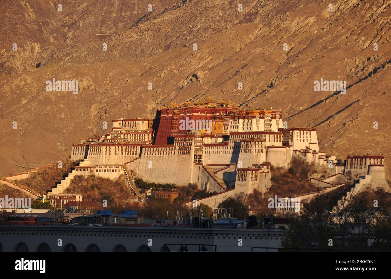 Potala palace in the morning sun, with the roofs of Lhasa city in the ...
