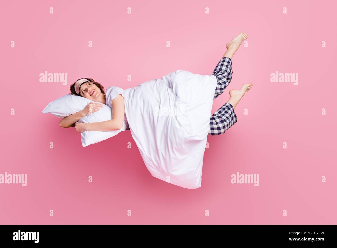 Full size photo of cheerful lady satisfied morning nap lying bed hug