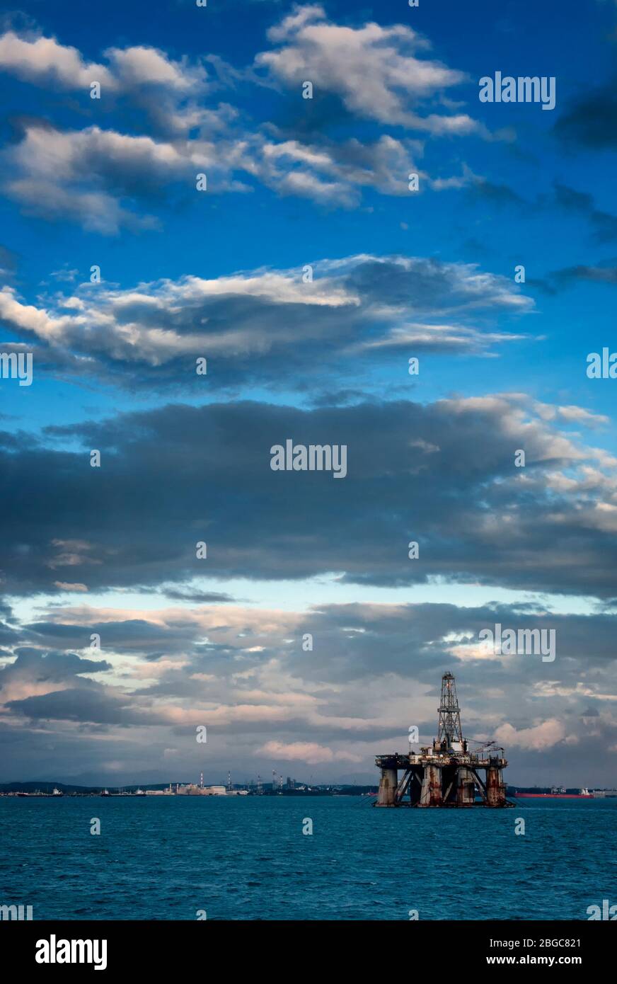 oil rig platform drilling at sea during sunset Stock Photo
