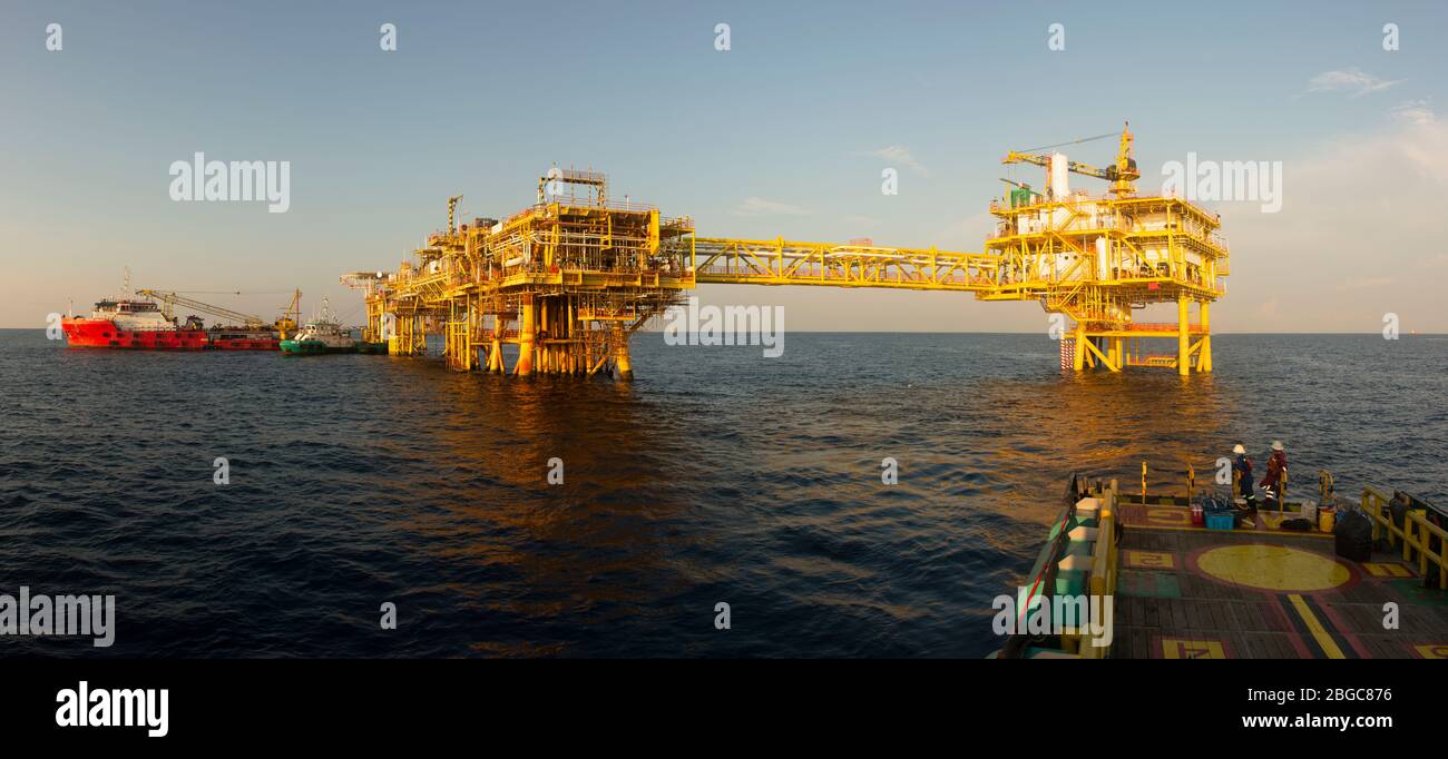 accommodation work barge alongside to oil platform offshore platform maintenance Stock Photo