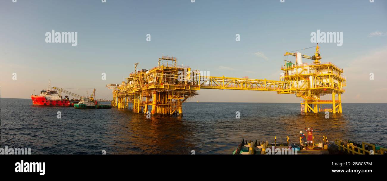 accommodation work barge alongside to oil platform offshore platform maintenance Stock Photo