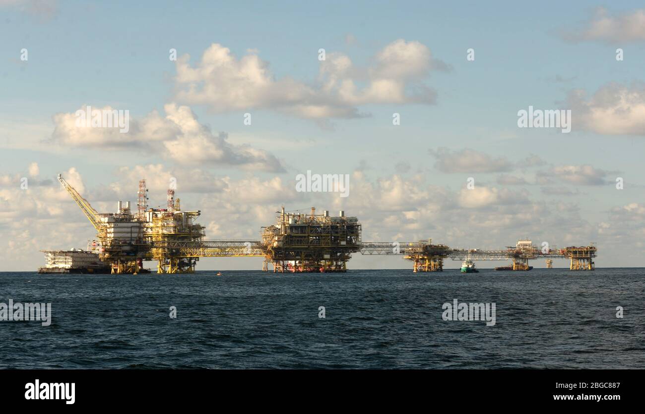 accommodation work boat attach to oil platform at sea form scheduled maintenance Stock Photo
