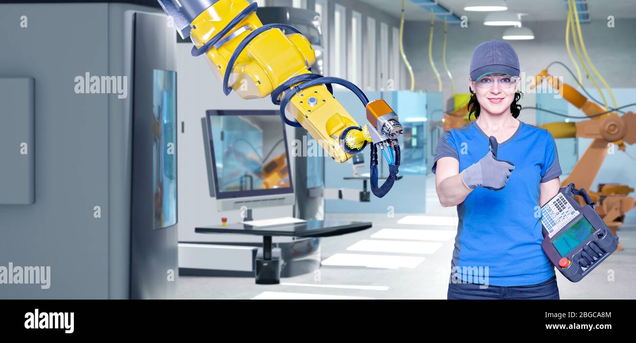 A young female technician while machine constructing in a manufacturing plant Stock Photo