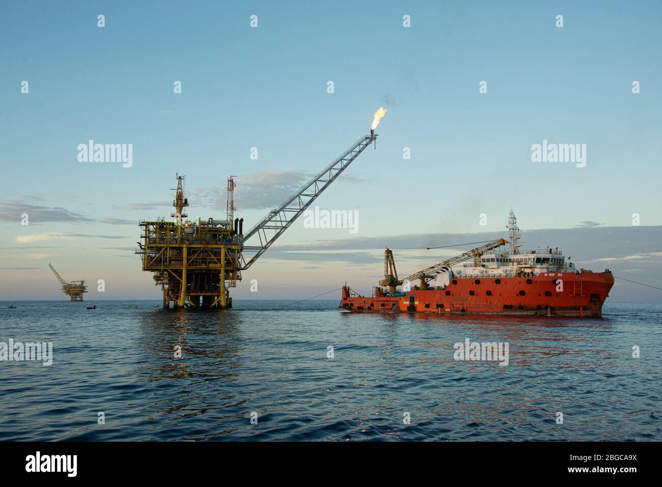 accommodation work barge alongside to oil platform offshore platform maintenance Stock Photo