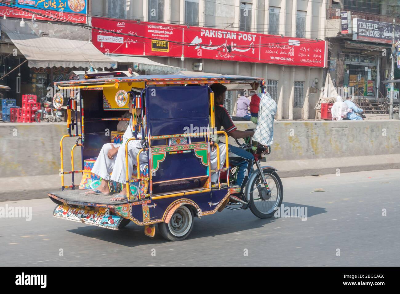 Everyday life in Lahore, Pakistan, with crowded streets, donkeys pulling carts, and rickshaws speeding through the streets Stock Photo