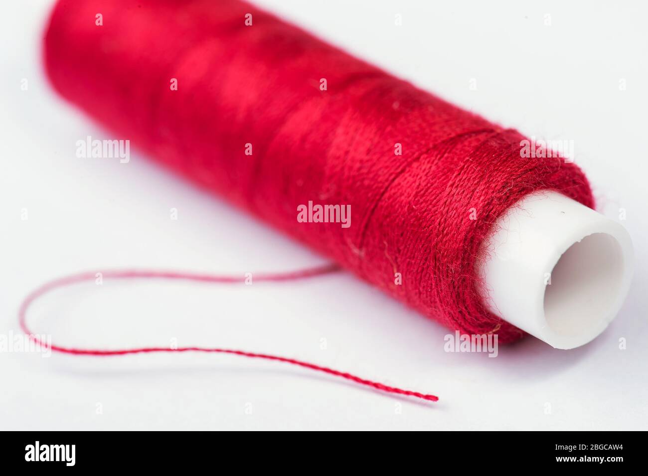 Close up photo of red sewing thread Stock Photo Alamy