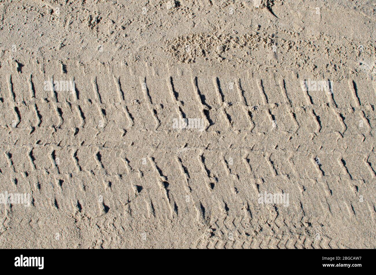 Tyre (tire) track on yellow sand Stock Photo