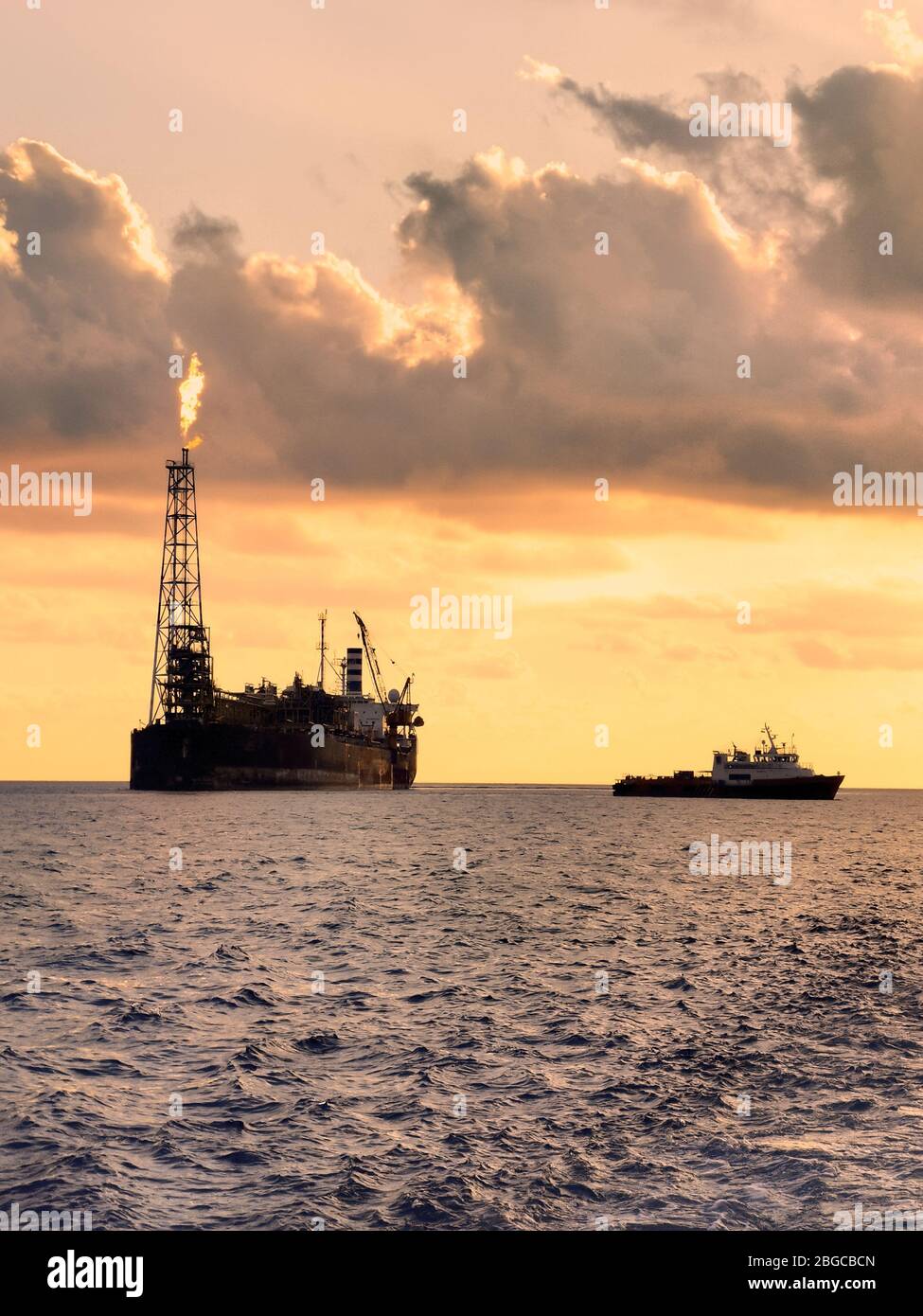 FPSO floating production storage and offloading at sea during sunset Stock Photo