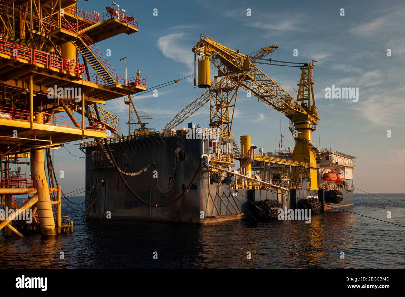 accommodation work barge alongside to oil platform offshore platform maintenance Stock Photo