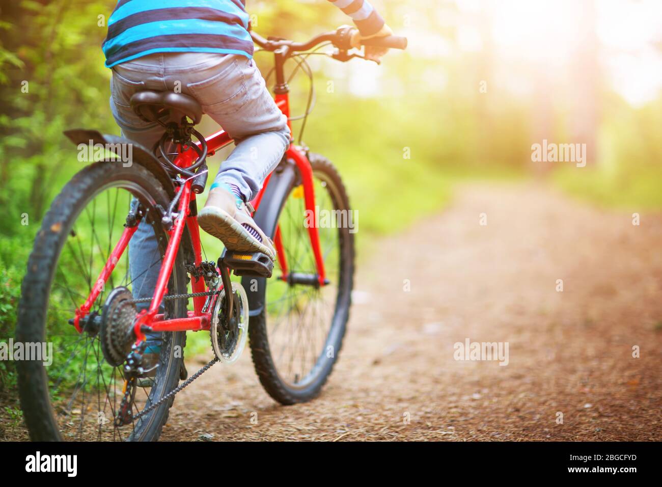 Back child riding bicycle in hi-res stock photography and images - Alamy