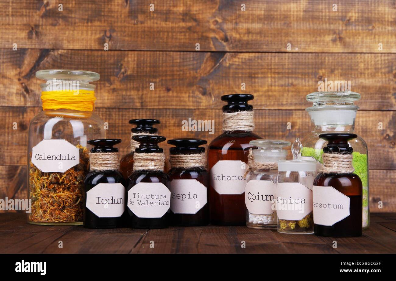Historic old pharmacy bottles with label on wooden background Stock