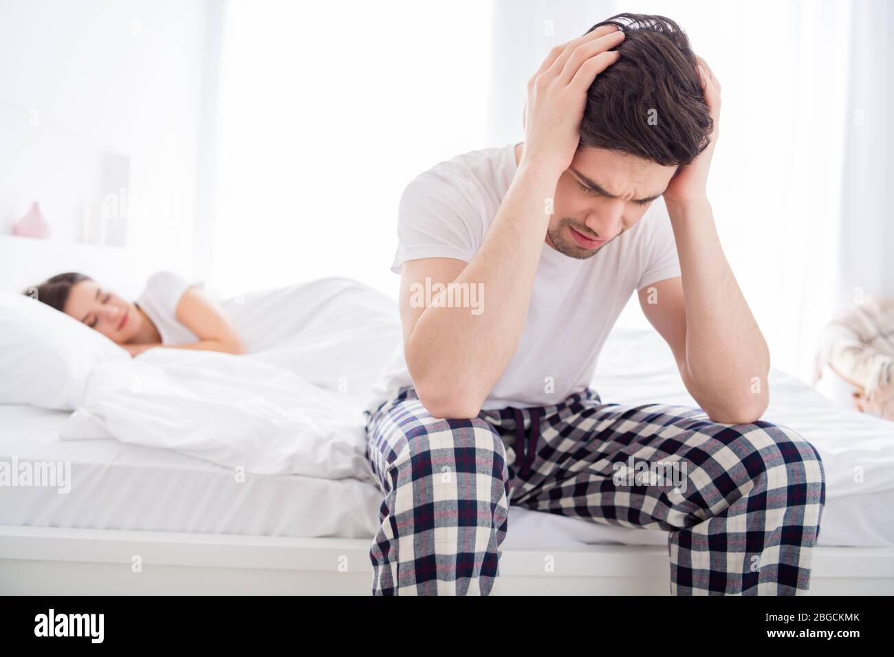 Photo of frustrated man sit bed suffer migraine head ache cant sleep