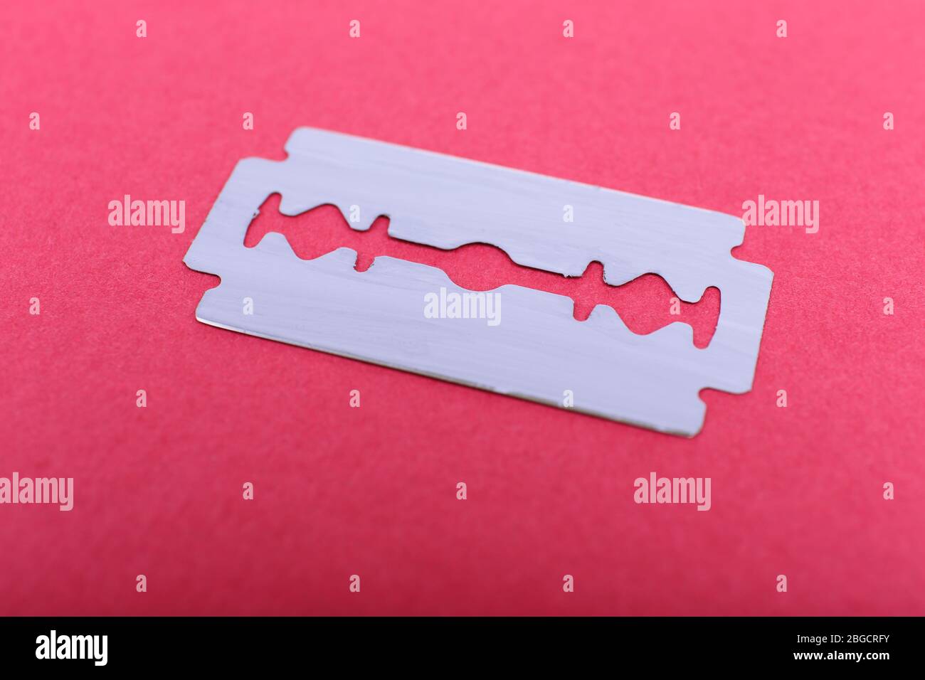 Razor blade on color background Stock Photo - Alamy