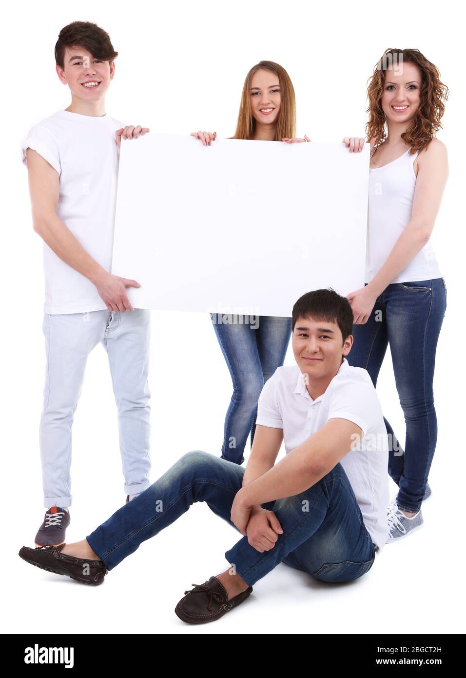 Group of happy young people holding blank poster isolated on white ...