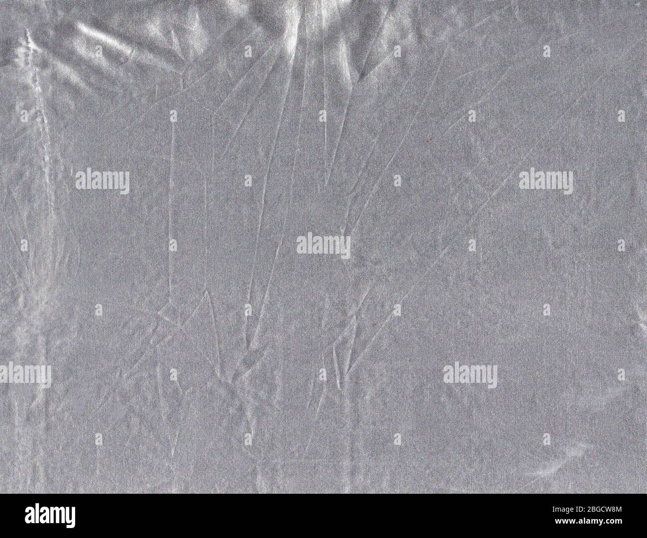 Silver fabric texture abstract background. Gray shiny chrome fabric  surface. Stock Photo