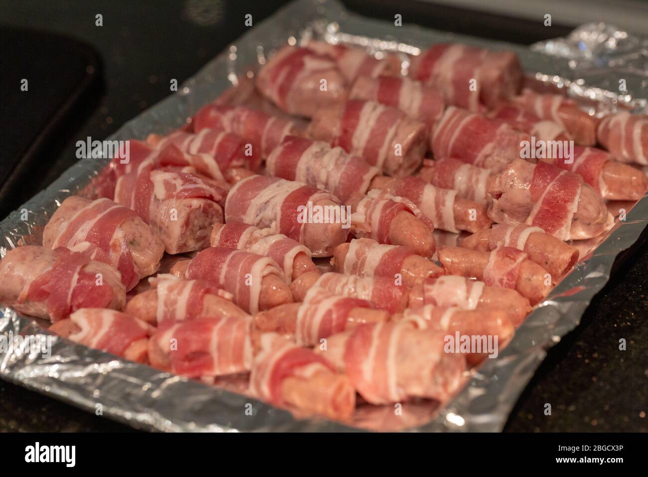Preparing pigs in blankets Stock Photo