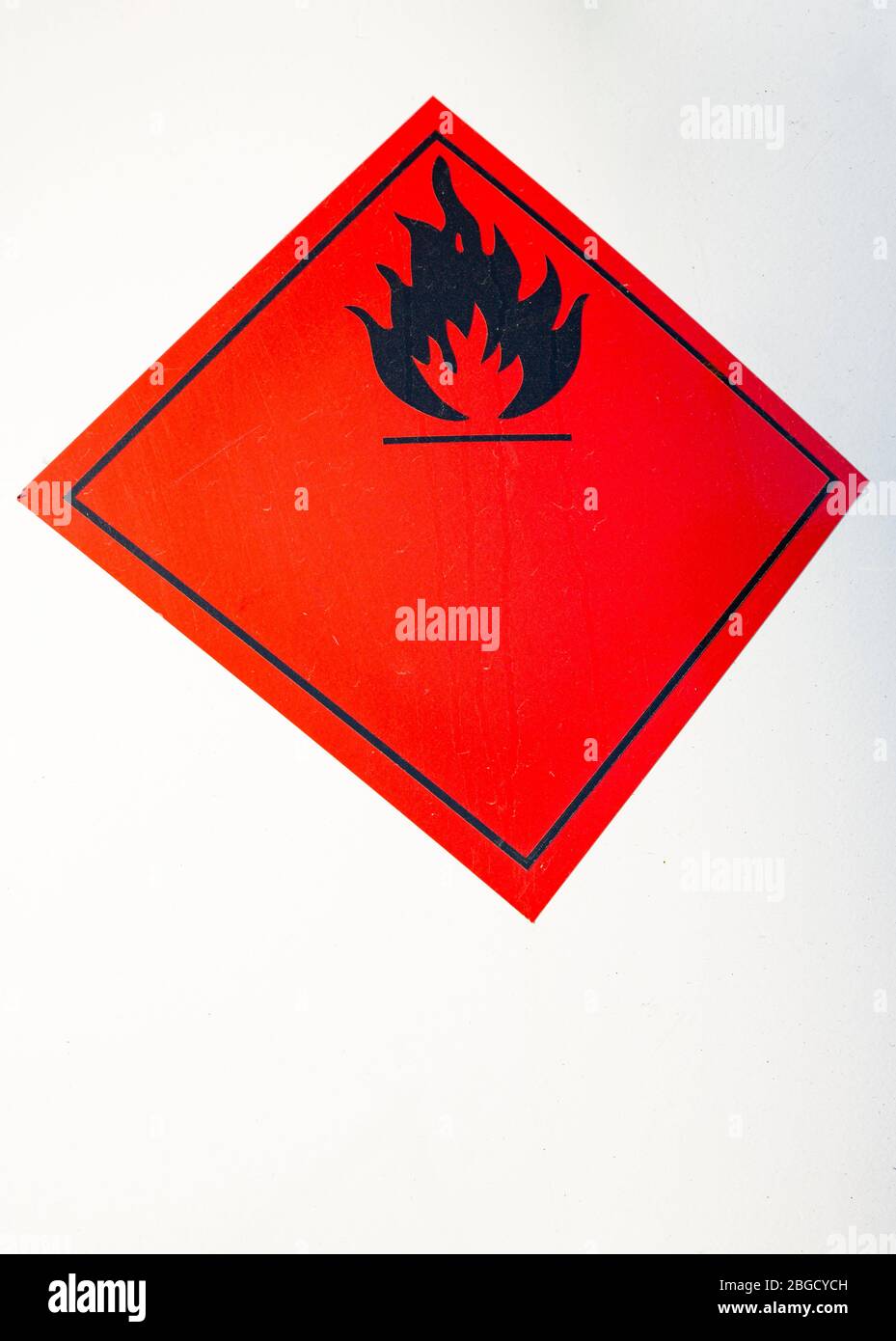 Closeup of red flammable sticker , warning about hazardous flammable materials Stock Photo