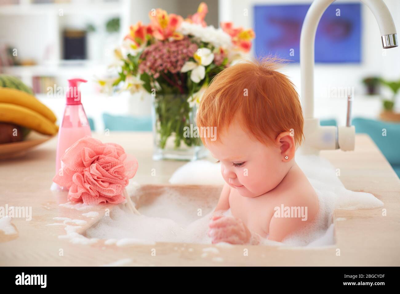 Infant bath in the kitchen sink hires stock photography and images Alamy