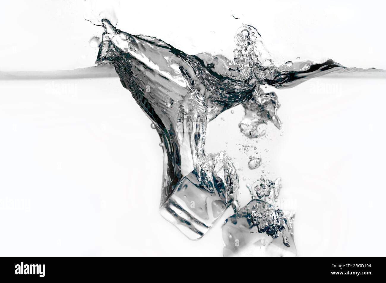 Ice cubes splashing into water isolated on white Stock Photo - Alamy